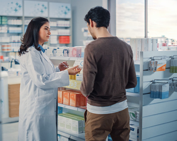 Compounding pharmacist talking to patient about custom medications.